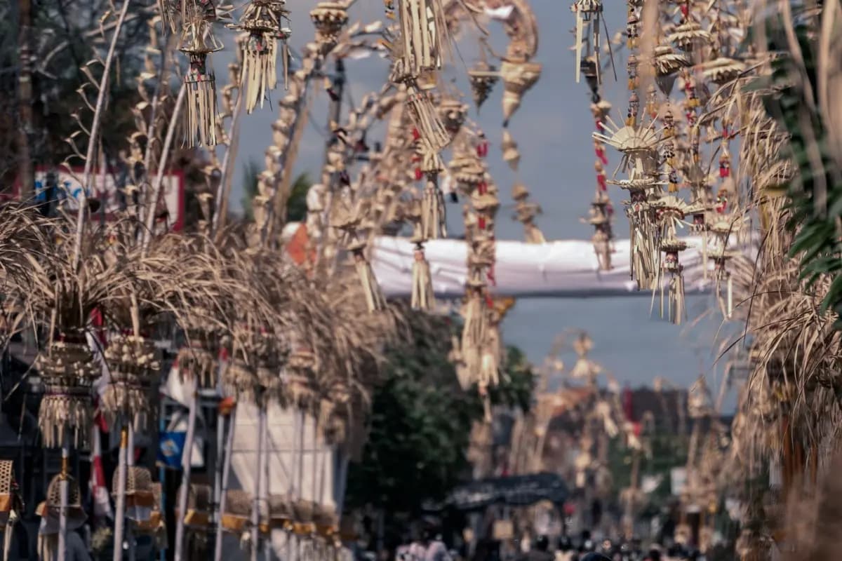 Traditional Galungan decorations line a Bali street during the Galungan celebration period.