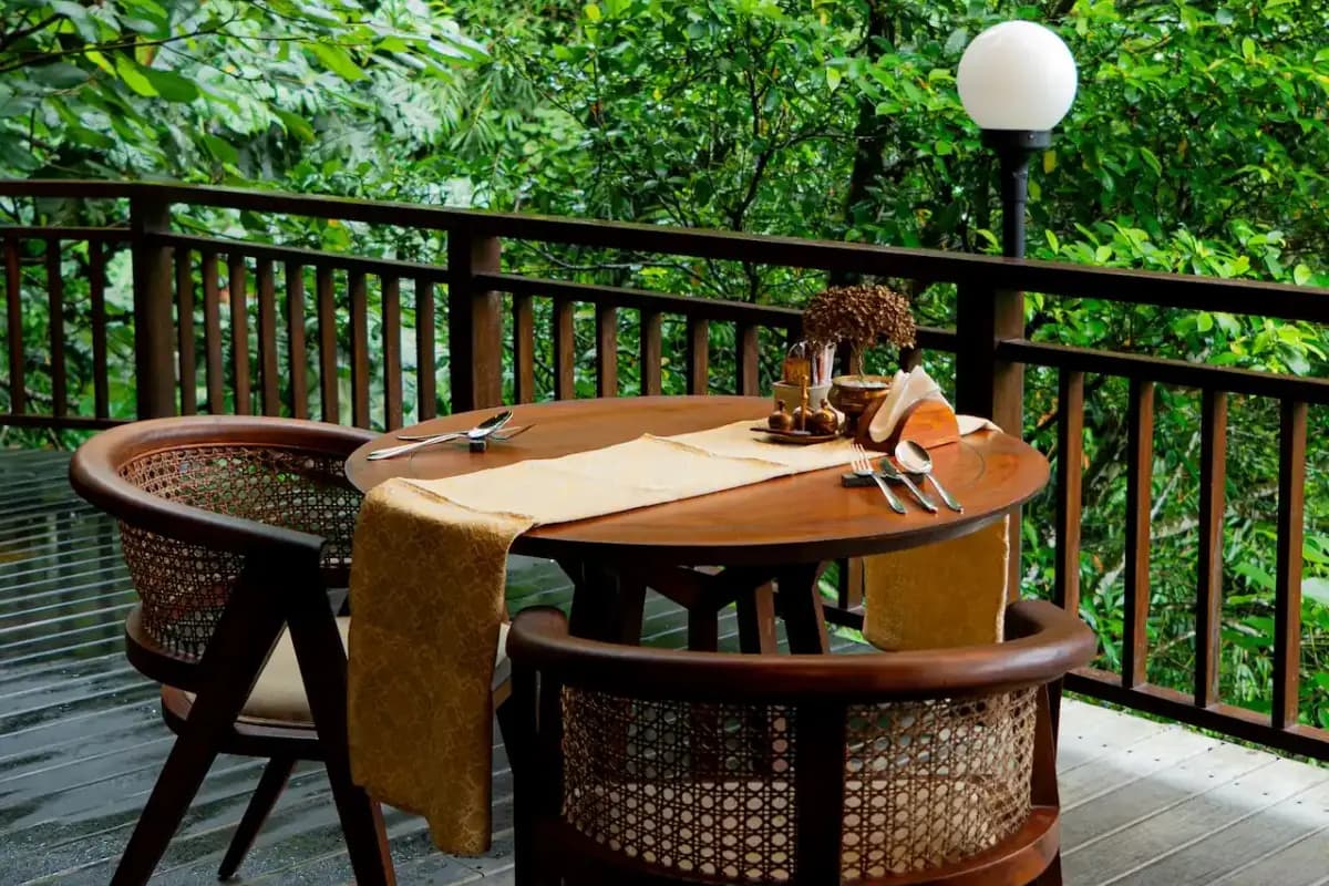 Table set on balcony overlooking jungle, showing quiet dining spot at a restaurant in Ubud.